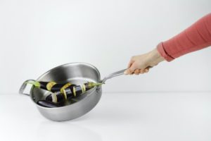 person holding stainless steel casserole