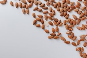 white table with tasty scattered almonds