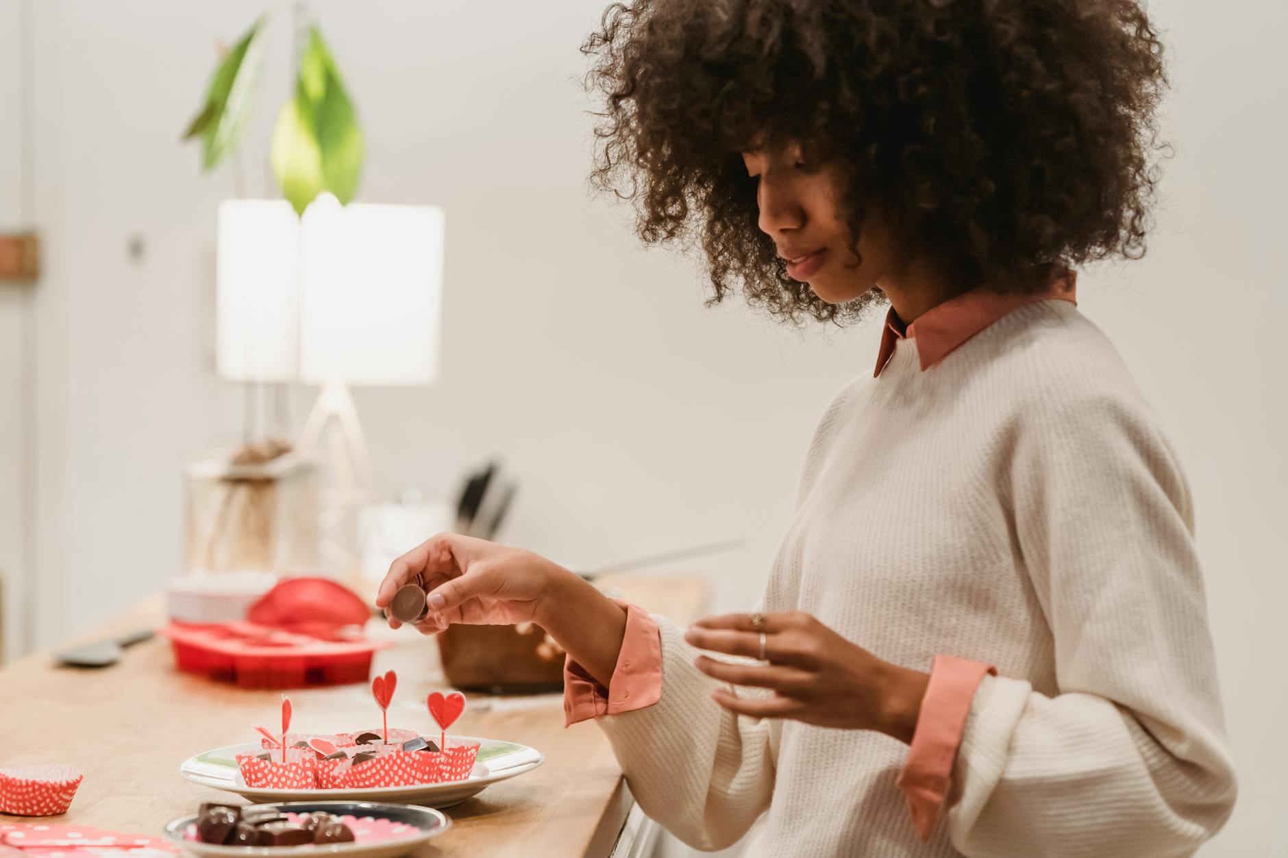 black woman cooking tasty dessert for saint valentine day